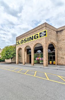 Vertical shot of a bankrupt retail anchor store with copy space above and below.