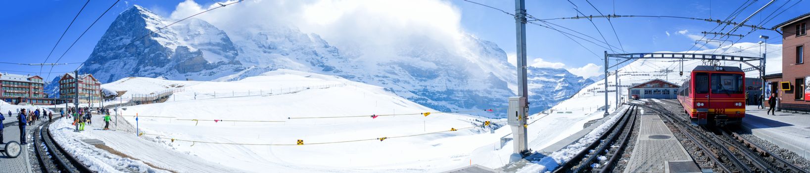 KLEINE SCHEIDEGG, SWITZERLAND - MARCH 28: Panoramic view Tourist train is coming down from the Jungfrau in Kleine Scheidegg, Switzerland on March 28 2017. It's a mountain pass at an elevation of 2,061m.