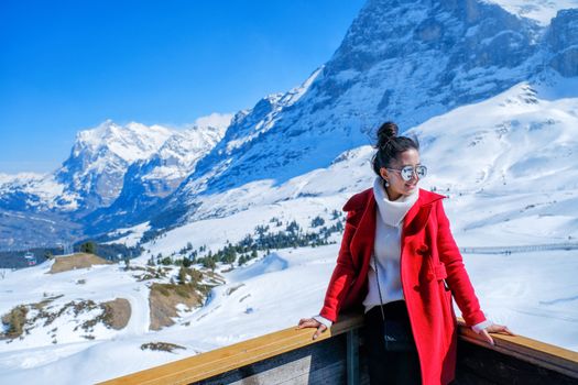 Young Woman Tourists see beautiful viewpoitn near Kleine Scheidegg station, along the railway from Interlaken to Jungfraujoch (3,466 m). In daylight atI Switzerland