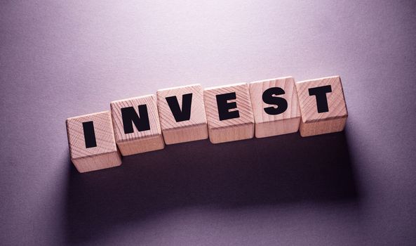 Invest Word Written on Wooden Cubes