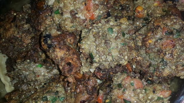 Closeup view with selective focus on delicious spicy fried round kebab served in a ceramic plate
