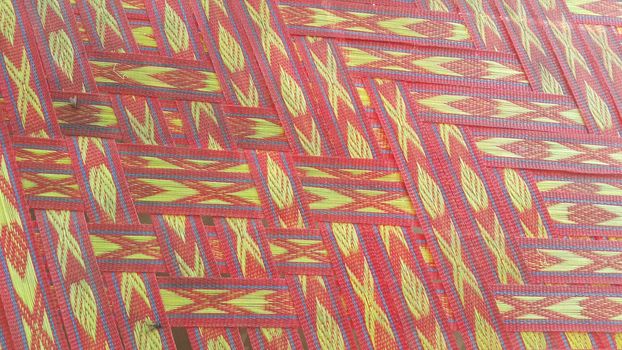 Colorful plastic woven stripes of traditional bed used in rural areas.