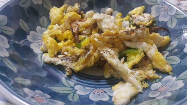 Closeup view of fried egg omelet dish in a fry pan. Home made egg omelet is served in breakfast.