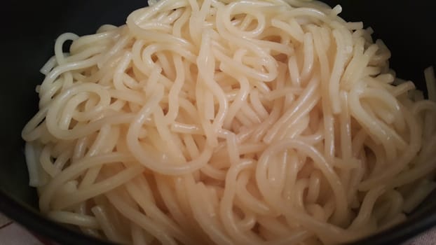 close up view of swirling noodles or spaghetti pasta for eating. Food background for fast foods