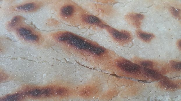 Closeup view of of traditional bread called Jawar roti or bhakri. Bhakri is a round flat unleavened bread often used in the cuisine of many Asian countries