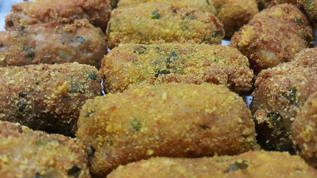 Closeup perspective view of home made spicy and delicious croquettes served with tea or other dishes during parties as fast food.