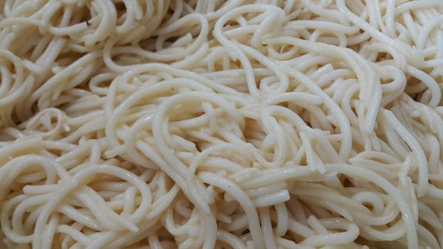 close up view of swirling noodles or spaghetti pasta for eating. Food background for fast foods