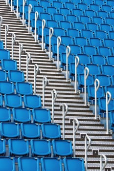 Blue stadium seats and a metallic staircase