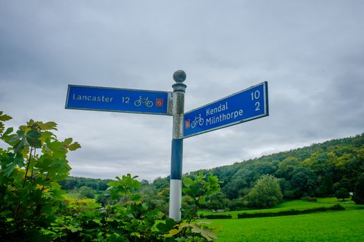 Blue Cycle directional sign at Beetham to Lancaster and Kendal