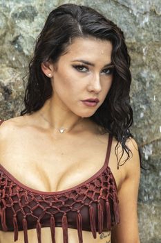 A gorgeous brunette model enjoys a day at the pool on a Caribbean island