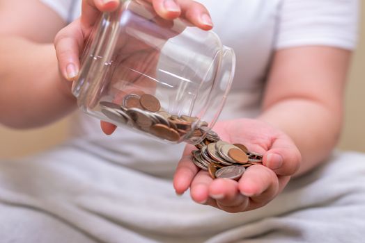 Save money and account banking for finance concept, Hand with coin on blurred background