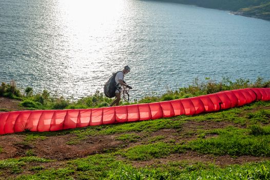 Phuket, Thailand - May 28, 2015 : Some people with parachute sport extreme on island sunset in twilight
