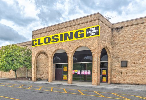 Horizontal shot of a bankrupt retail anchor store going out of business following the pandemic.