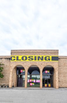 Vertical shot of an out of business store in vertical format with foreground copy space.