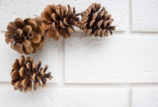 Pine cones lie on white bricks.The concept of a new year, Christmas, holiday