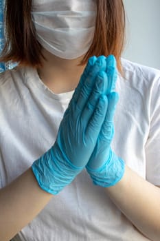Hands in blue protective gloves, medical mask on the face. Coronavirus, the concept COVID-19