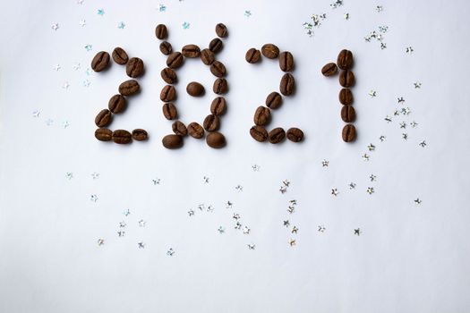 Image of the new year 2021 numbers from coffee beans on a white background