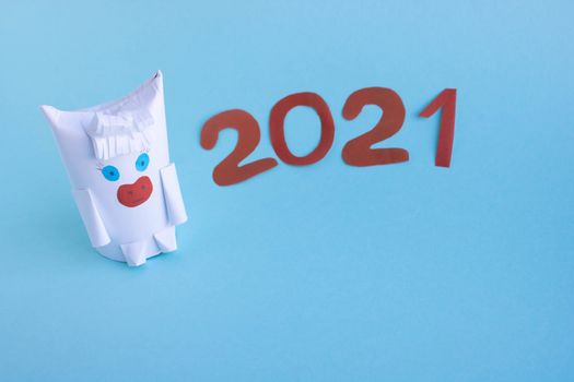 Funny white bull made of paper and toilet roll on a blue background.New year's fantasy. New year according to the Chinese calendar. 2021
