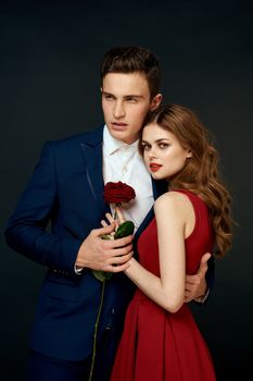 luxury couple hug romance relationship rose over dark isolated background. High quality photo