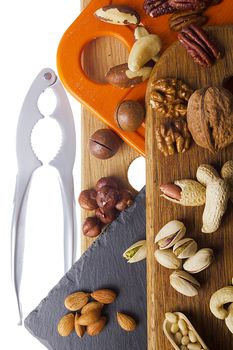 Mix of nuts on different cutting boards on a white background