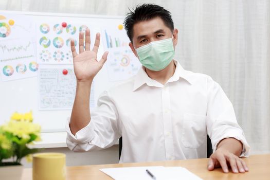 Asian business man using video call contact with friend, customers, partners from home. coronavirus outbreak crisis Business people wear protective face mask work from home with video conference.