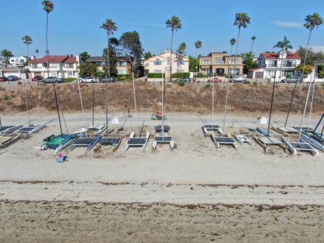 Aerial view of Mission Bay and beaches with sailboat in San Diego, California. USA. Community built on a sandbar with villas and recreational Mission Bay Park. Californian beach-lifestyle.