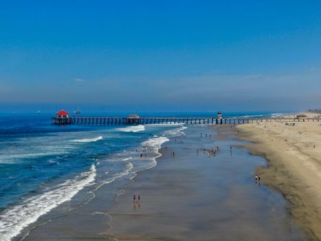 Aerial view of Huntington Pier, beach and coastline during sunny summer day, Southeast of Los Angeles. California. destination for surfer and tourist.