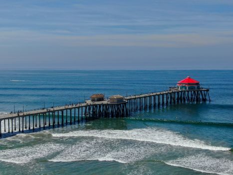 Aerial view of Huntington Pier, beach and coastline during sunny summer day, Southeast of Los Angeles. California. destination for surfer and tourist.