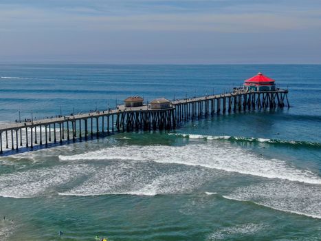 Aerial view of Huntington Pier, beach and coastline during sunny summer day, Southeast of Los Angeles. California. destination for surfer and tourist.