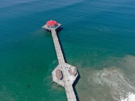 Aerial view of Huntington Pier, beach and coastline during sunny summer day, Southeast of Los Angeles. California. destination for surfer and tourist.