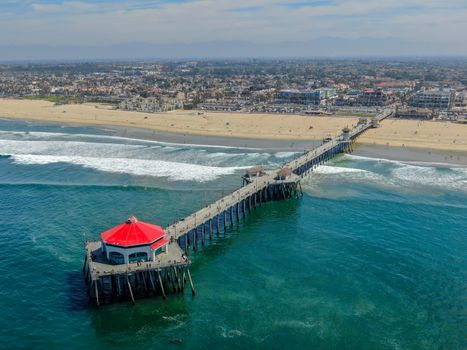 Aerial view of Huntington Pier, beach and coastline during sunny summer day, Southeast of Los Angeles. California. destination for surfer and tourist.