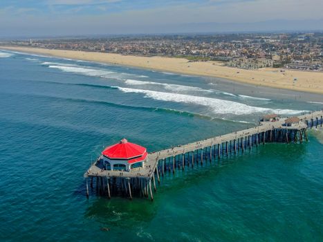 Aerial view of Huntington Pier, beach and coastline during sunny summer day, Southeast of Los Angeles. California. destination for surfer and tourist.