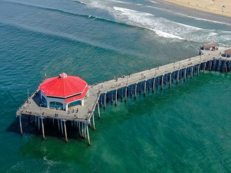 Aerial view of Huntington Pier, beach and coastline during sunny summer day, Southeast of Los Angeles. California. destination for surfer and tourist.