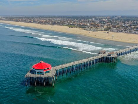 Aerial view of Huntington Pier, beach and coastline during sunny summer day, Southeast of Los Angeles. California. destination for surfer and tourist.
