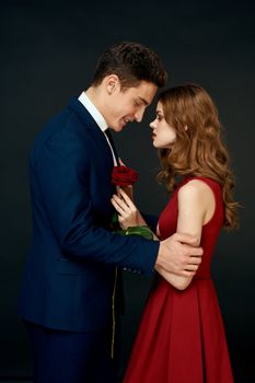 luxury couple hug romance relationship rose over dark isolated background. High quality photo