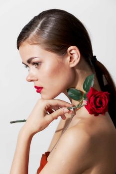 Woman with flower Red lips side view glamor bright makeup cropped view