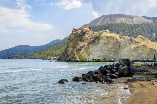Beach of the island of vulcano with its volcanic rocks and rock formations of colored by the minerals