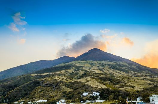 Last constructions from the beginning of the slope with vegetation to the top of the volcano stromboli surrounded by its fumaroles