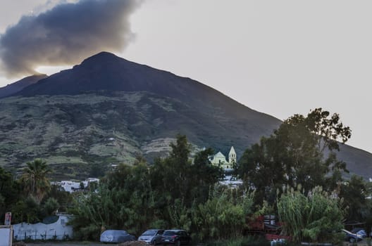 Island stromboli village and to the bottom the vulcan making smoke