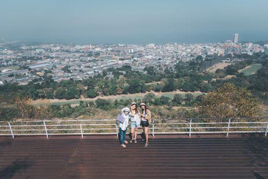 Asian pretty cute women with hat relax at seaside city landscape viewpoint on mountain with happy and freedom emotion in concept travel, vacation, leisure in life