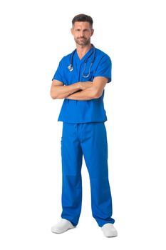 Male nurse in blue uniform with stethoscope standing with arms crossed isolated on white background, full length portrait