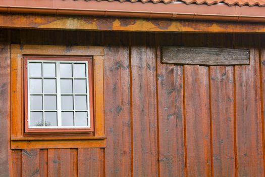 Wooden wall, window and door texture of a Norwegian cabin hut in Hemsedal.