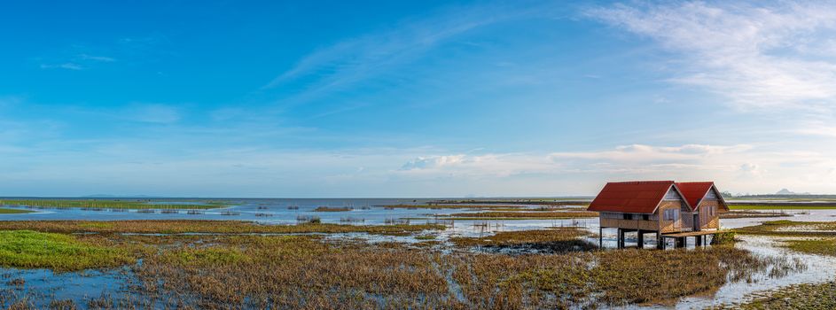 Abandoned house in the middle of the lake, is a landmark, is an important tourist attraction, of Phatthalung province, which has a nice atmosphere, and is beautiful in the evening, with the soft sun, Panorama