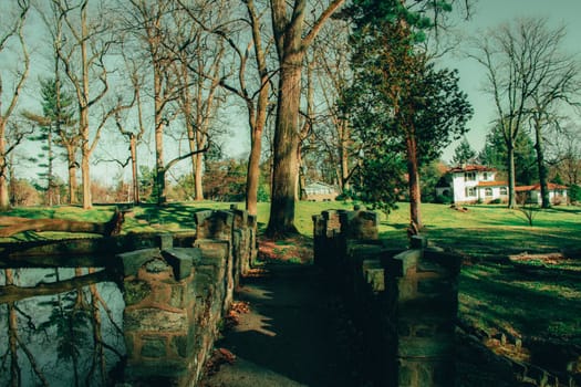 An Ornate Cobblestone Bridge Over a Waterfall at the Elkins Estate