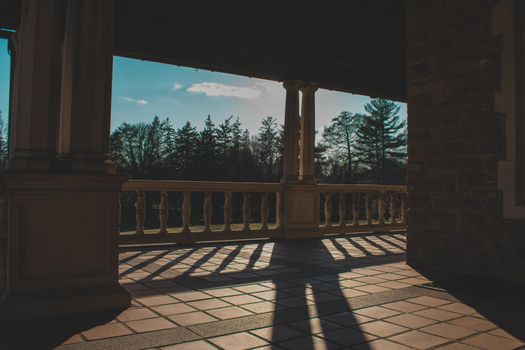 A Gorgeous Balcony at the Elkins Estate With a View of Trees and a Clear Blue Sky