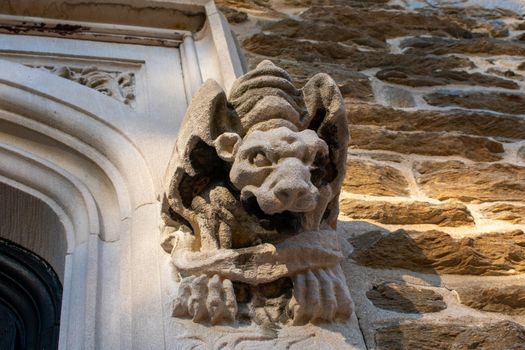 A Gargoyle Statue Sticking Out of the Cobblestone Wall Next to a Doorway at the Elkins Estate