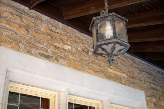 An Old Fashioned Lamp Hanging From a Detailed Ceiling of a Balcony at the Elkins Estate