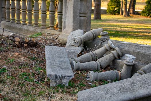 An Ornate and Detailed Borken Concrete Fence Laying in the Grass at Elkins Estate