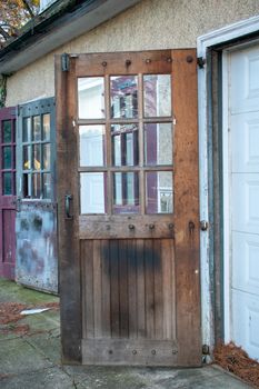 An Old Wooden Door With Glass Windows on an Antique Garage in Suburban Pennsylvania