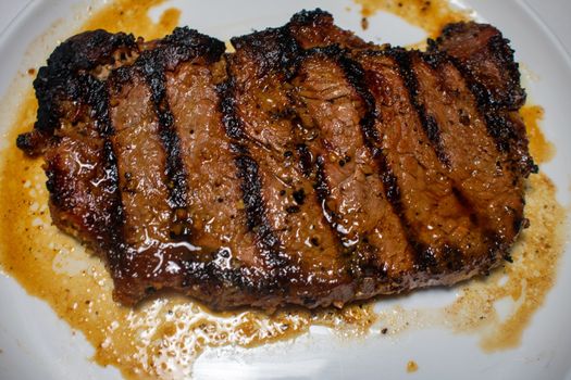 A Perfectly Cooked Steak With Grill Lines Plated on a Pure White Background